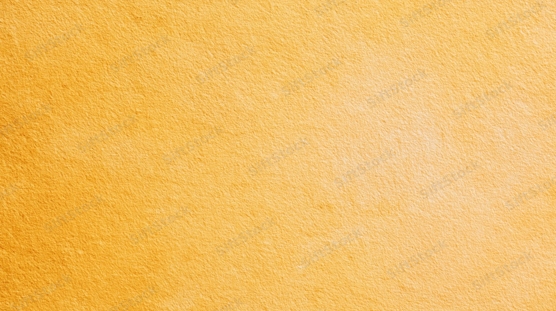 A smooth yellow textured surface with a warm gradient and soft light, serving as a clean background