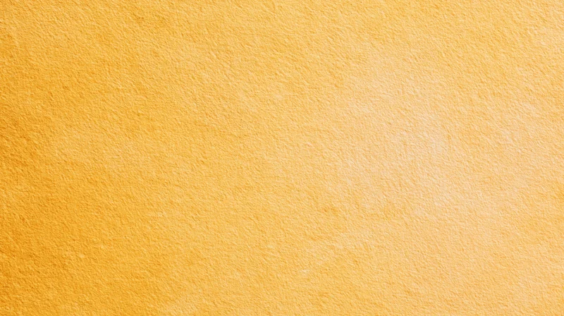 A smooth yellow textured surface with a warm gradient and soft light, serving as a clean background
