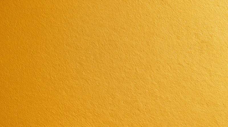 A smooth yellow textured surface filling the frame as a uniform background