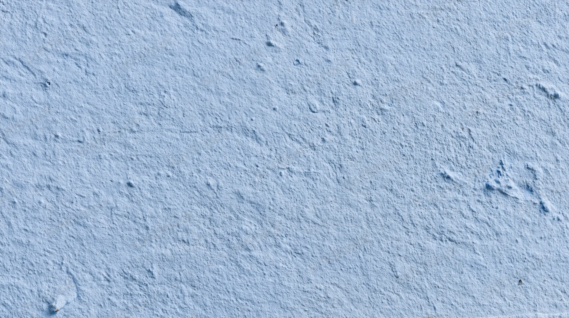 Close-up of a textured blue plaster wall surface