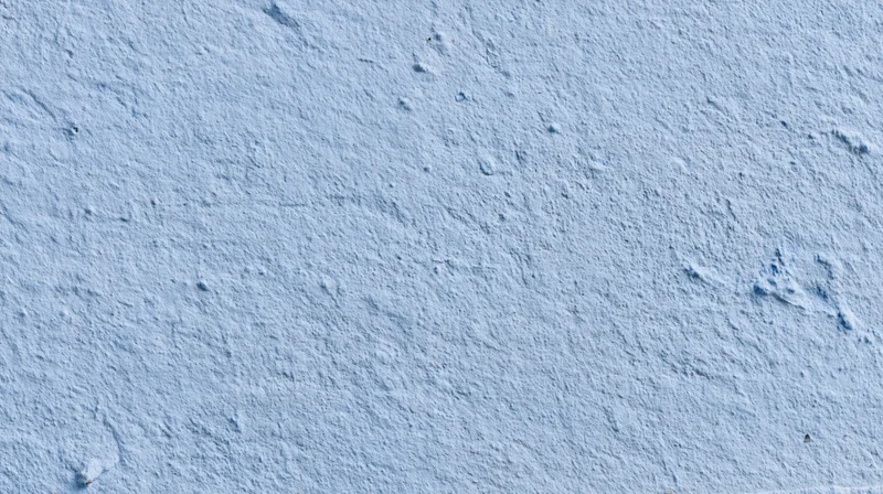 Close-up of a textured blue plaster wall surface