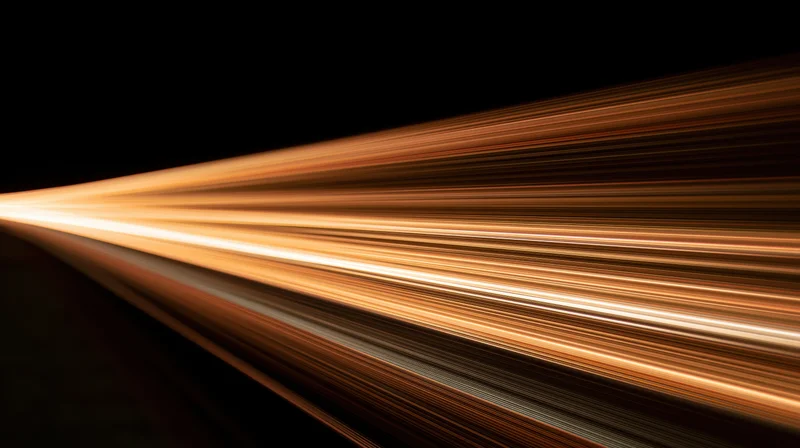 Streaks of warm light moving across a dark background in a dynamic diagonal pattern