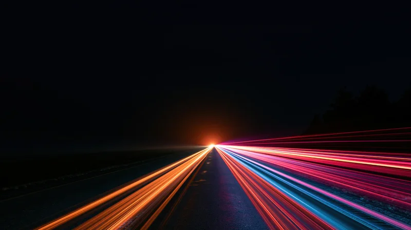 Long exposure light trails from moving vehicles on a highway at night