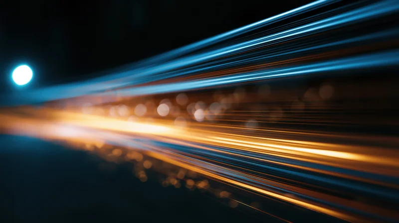 Streaks of light from moving vehicles on a dark road at night