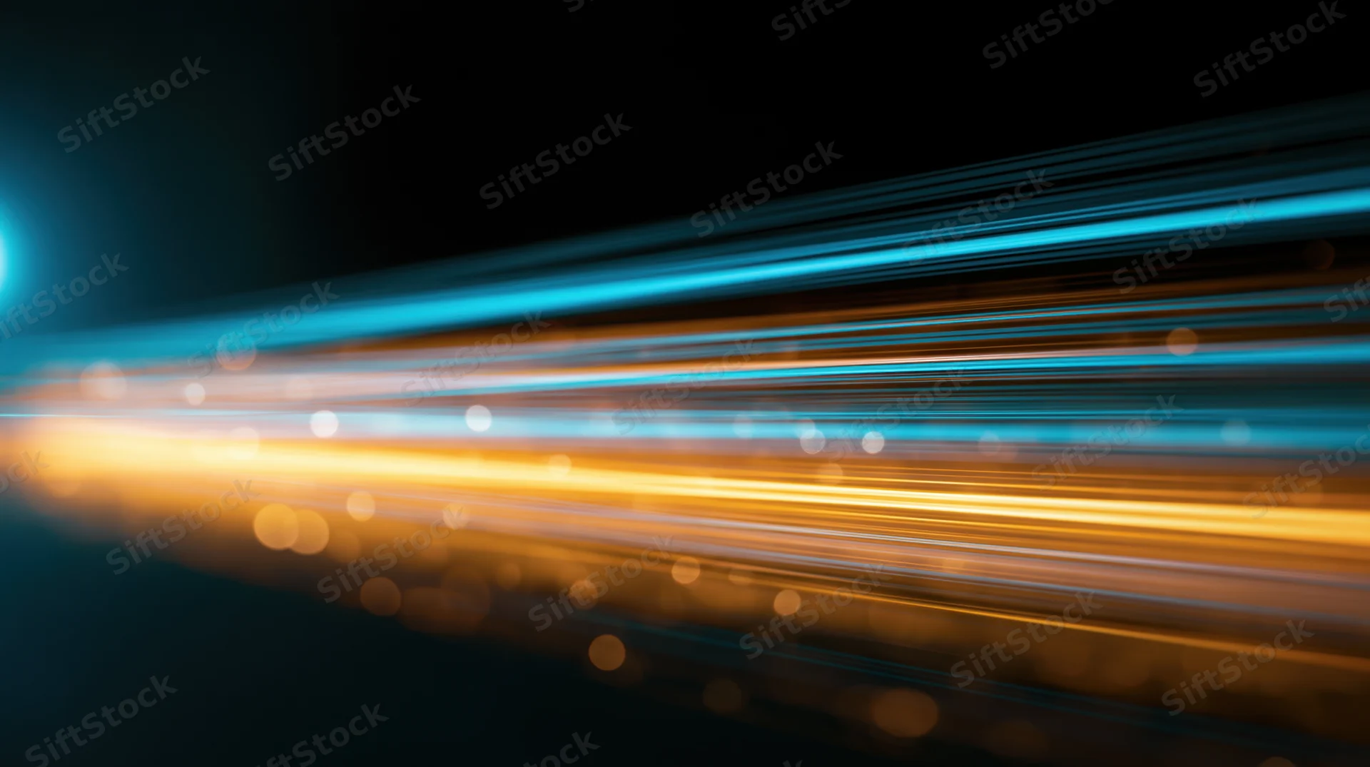 Streaks of blue and orange light moving across a dark background with bokeh highlights