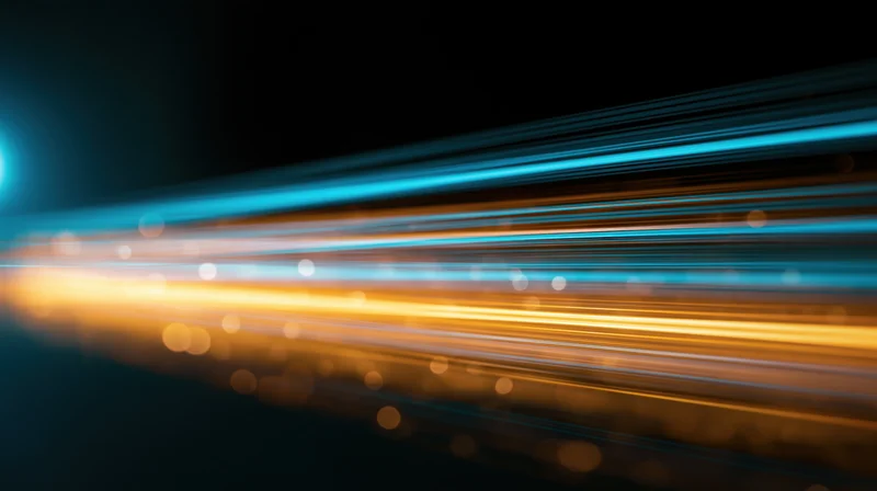 Streaks of blue and orange light moving across a dark background with bokeh highlights