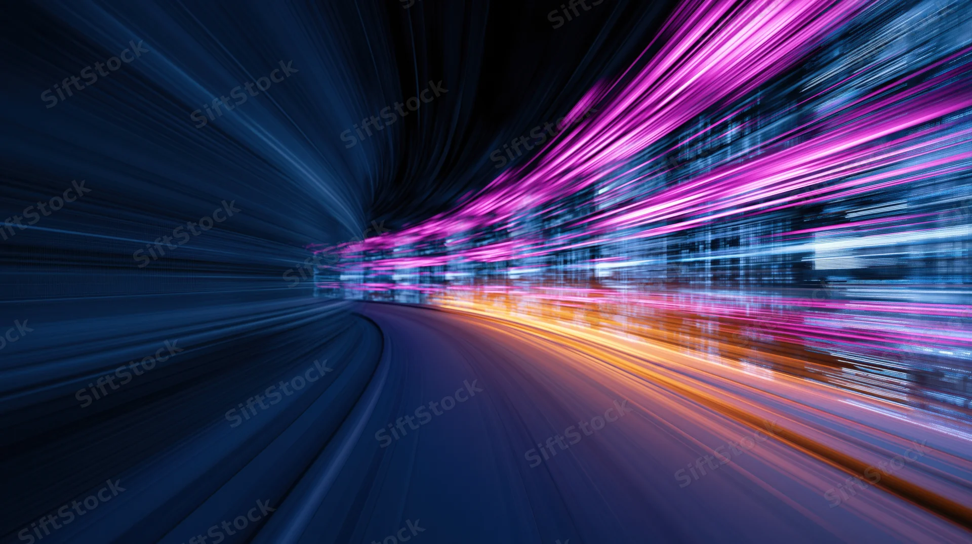 Abstract light streaks moving through a dark tunnel at high speed
