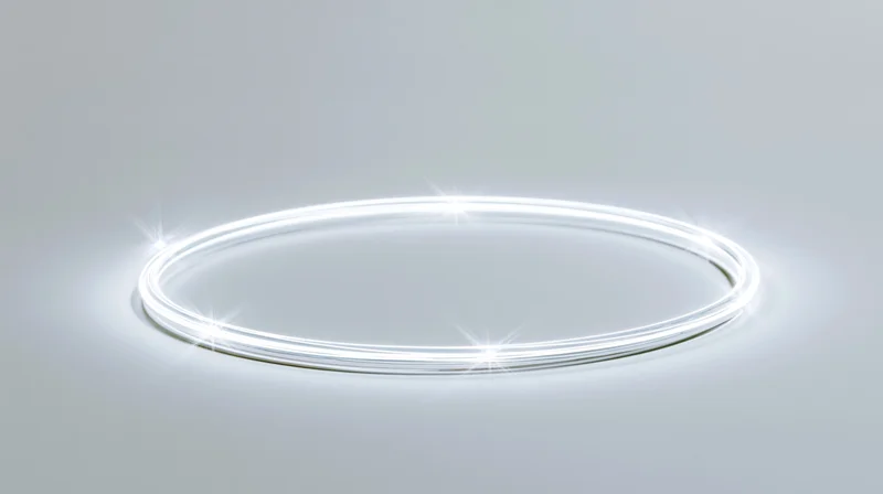 Glowing white circular ring on a smooth gradient surface with copyspace