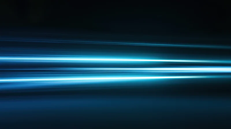 Horizontal blue light streaks glowing across a dark background with motion blur