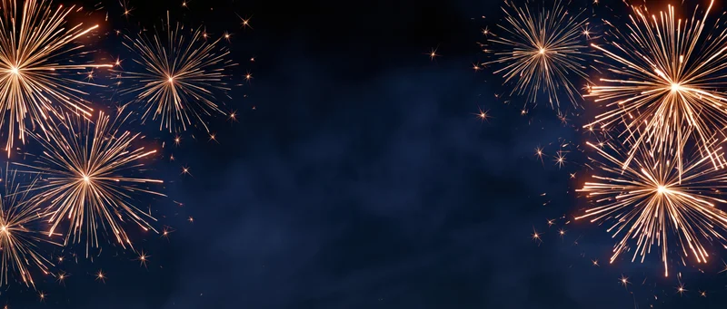 Fireworks exploding in golden bursts across dark night sky with central copyspace