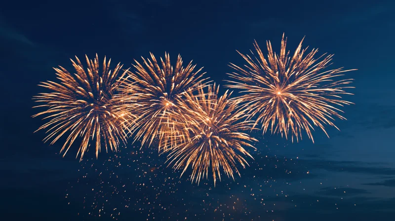 Golden fireworks exploding in the dark night sky during a celebration