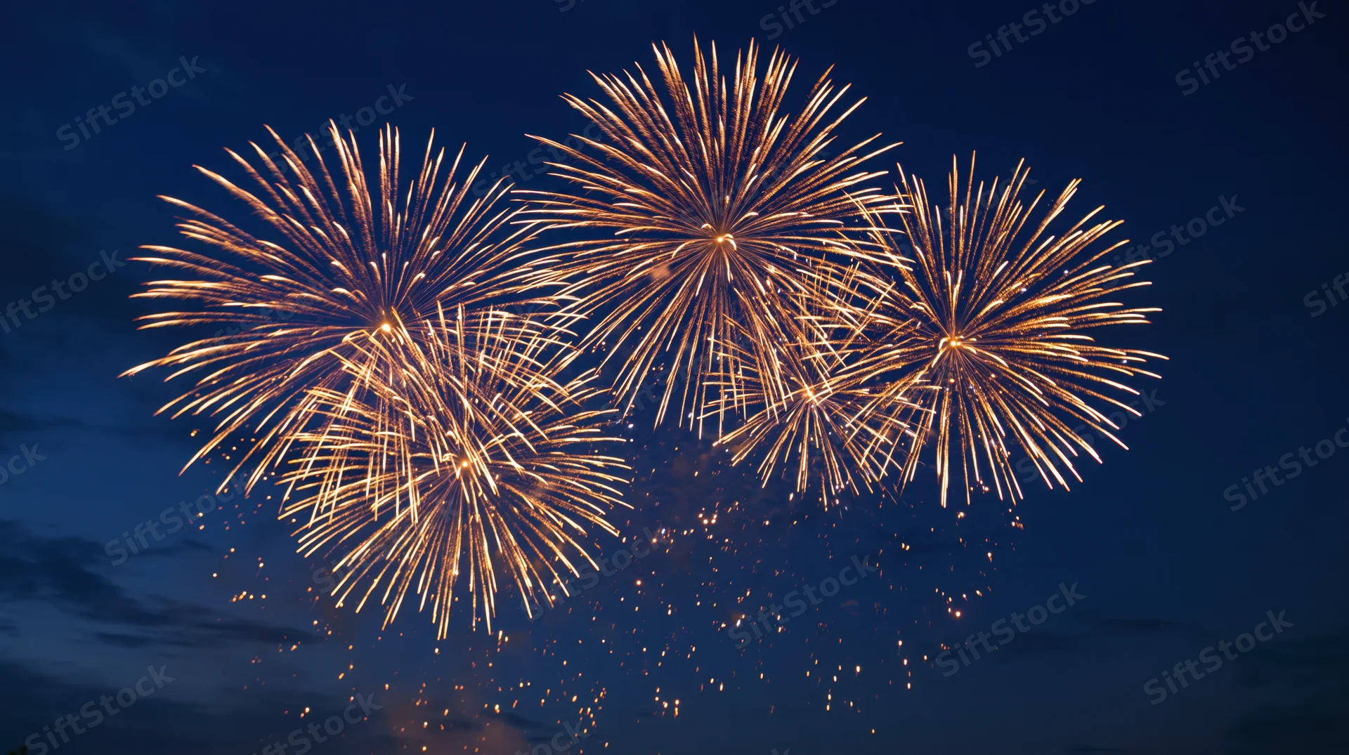 Golden fireworks bursting in the night sky during a celebration