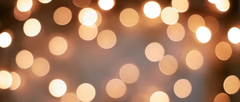 Blurred warm circular lights arranged as a festive background with copyspace