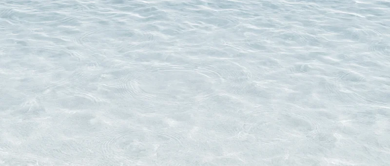 Calm rippling water surface over sandy bottom in shallow clear ocean