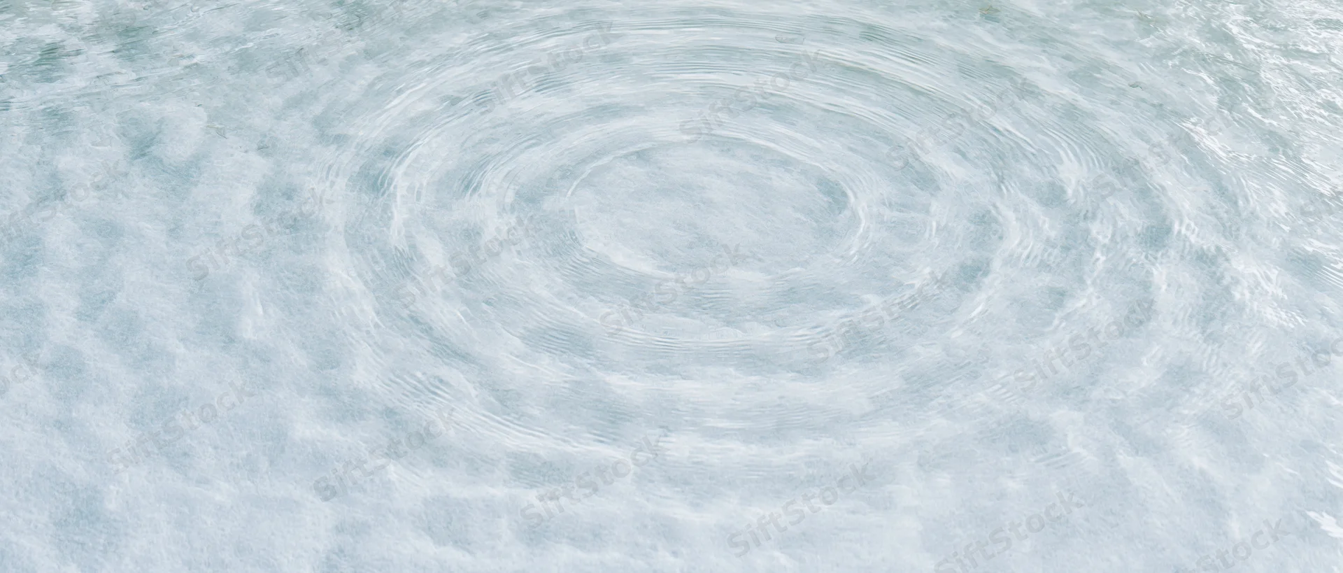 Circular ripples spreading across a calm water surface