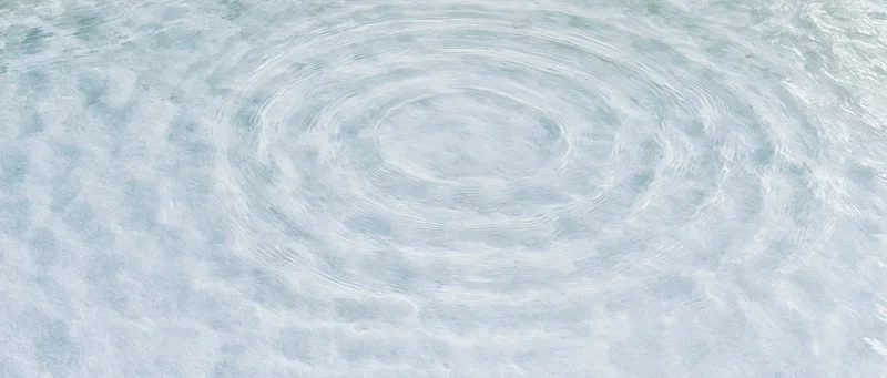 Circular ripples spreading across a calm water surface