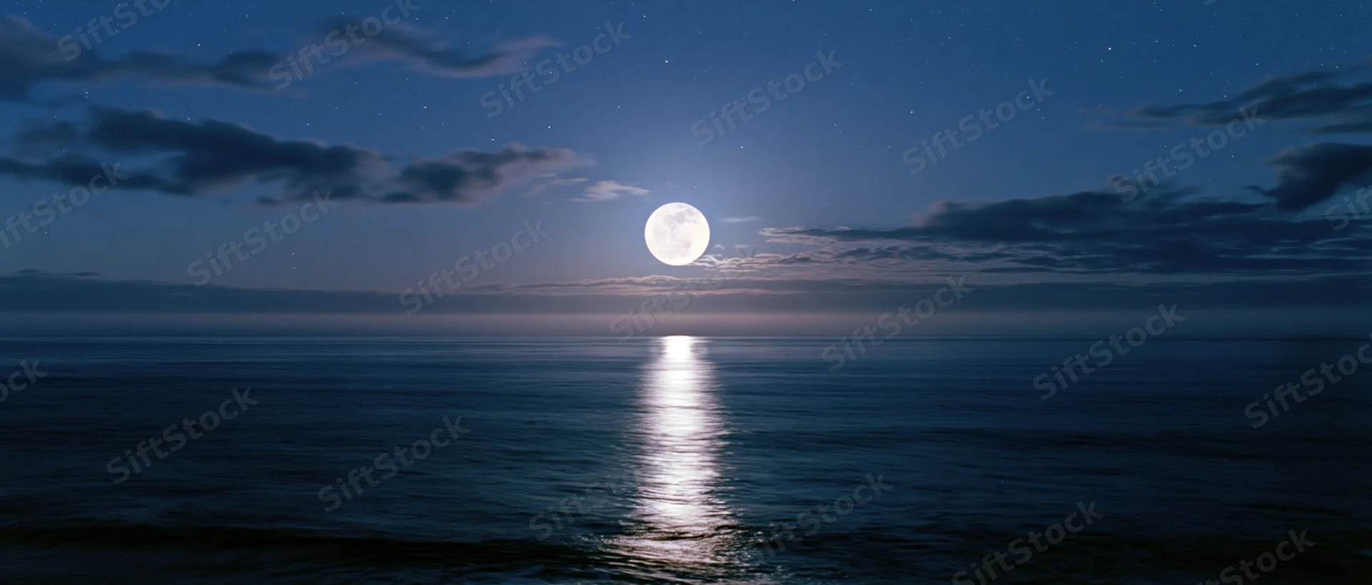 Full moon reflecting on calm ocean surface at night