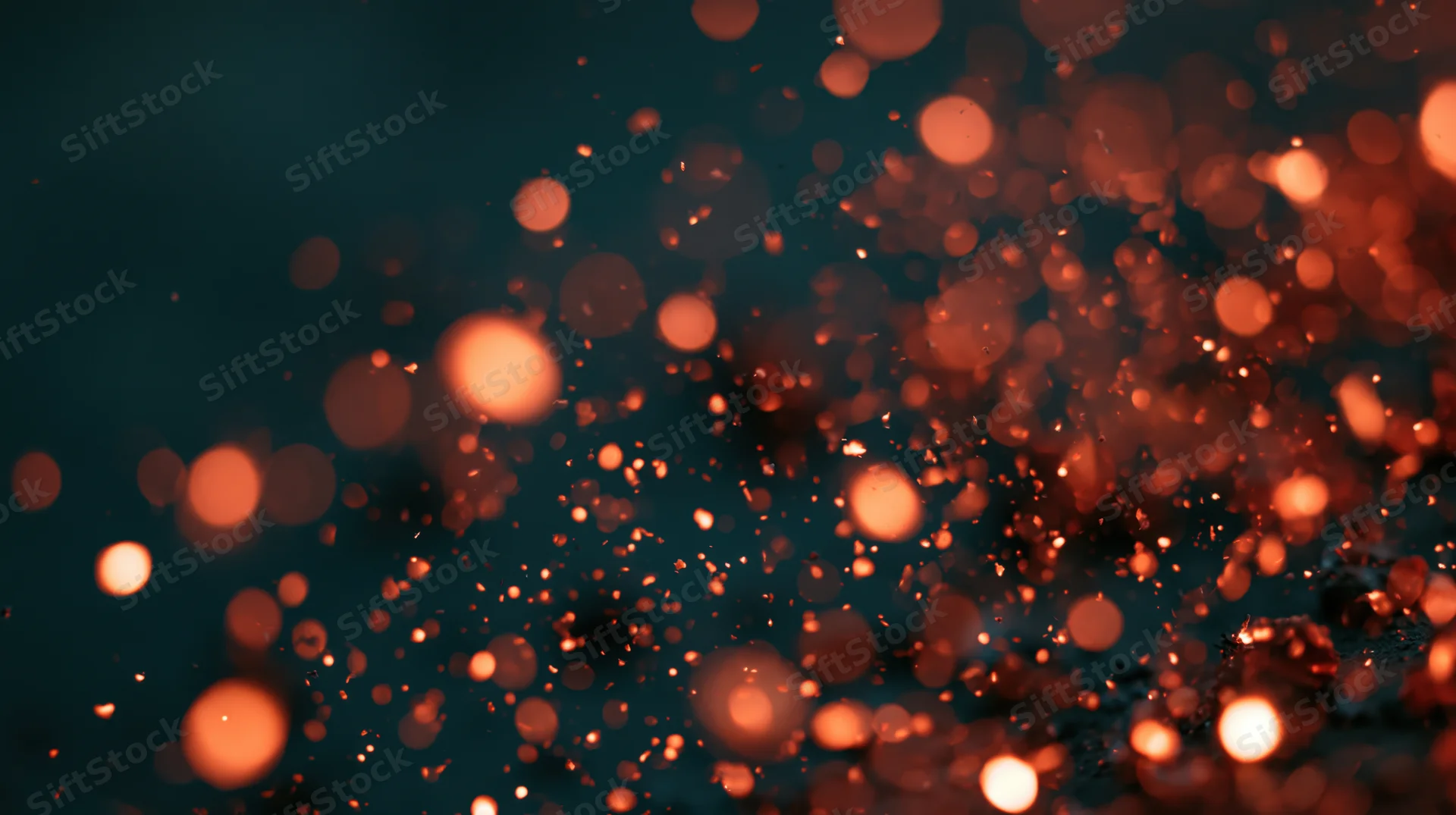 Glowing orange bokeh lights floating in dark space with soft blur and warm glow