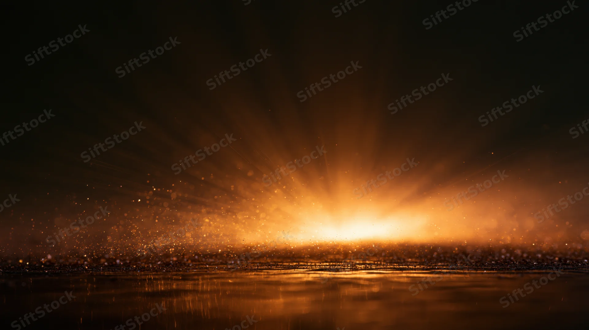 Golden sunrise over calm ocean with light rays and floating particles reflecting on water surface