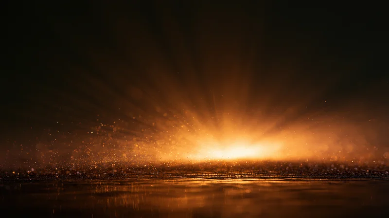 Golden sunrise over calm ocean with light rays and floating particles reflecting on water surface