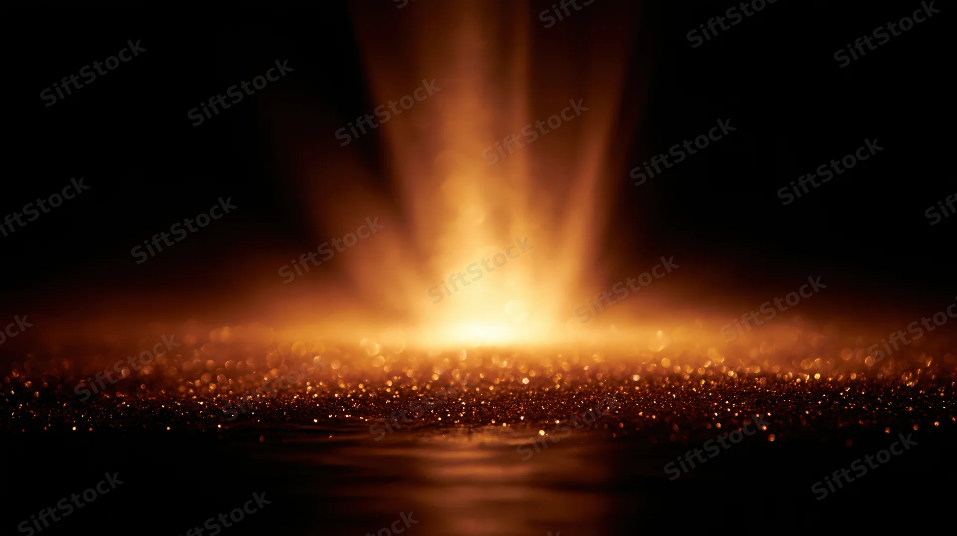 Golden light beam glowing over sparkling surface in dark space