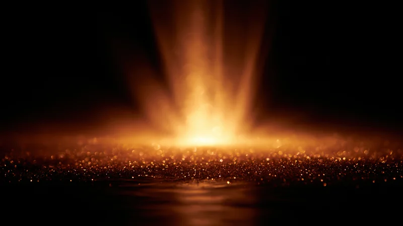 Golden light beam glowing over sparkling surface in dark space