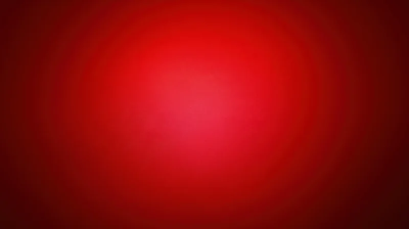 A red gradient background with soft radial light centered in the frame