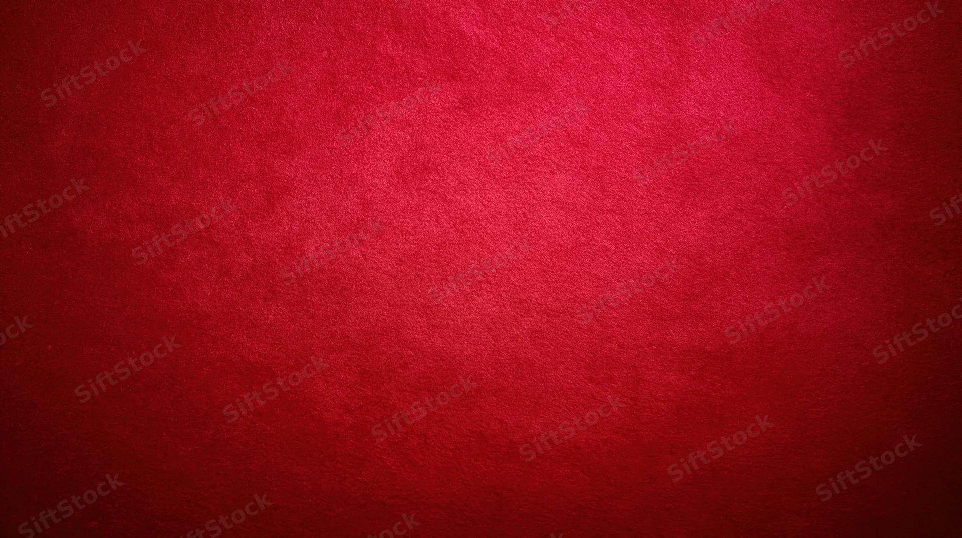 Deep red textured fabric background with soft gradient and copyspace