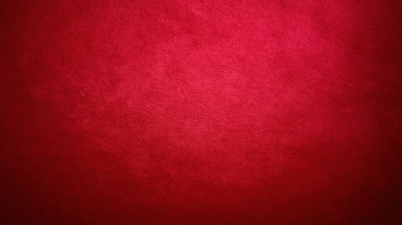 Deep red textured fabric background with soft gradient and copyspace