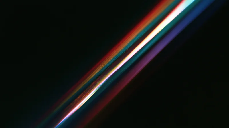 Diagonal streaks of rainbow-colored light moving across a dark background
