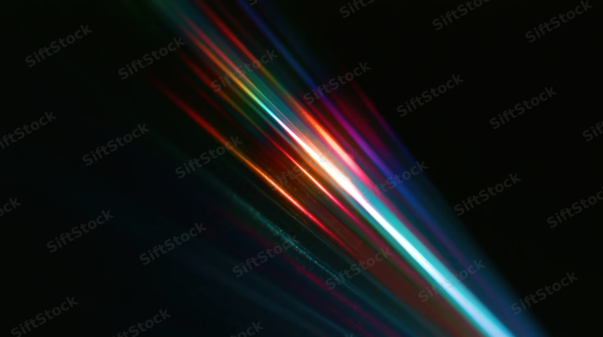 Colorful light streaks moving diagonally across a dark background