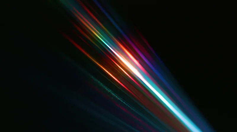 Colorful light streaks moving diagonally across a dark background