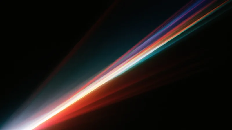 Diagonal streaks of colorful light moving across a dark background