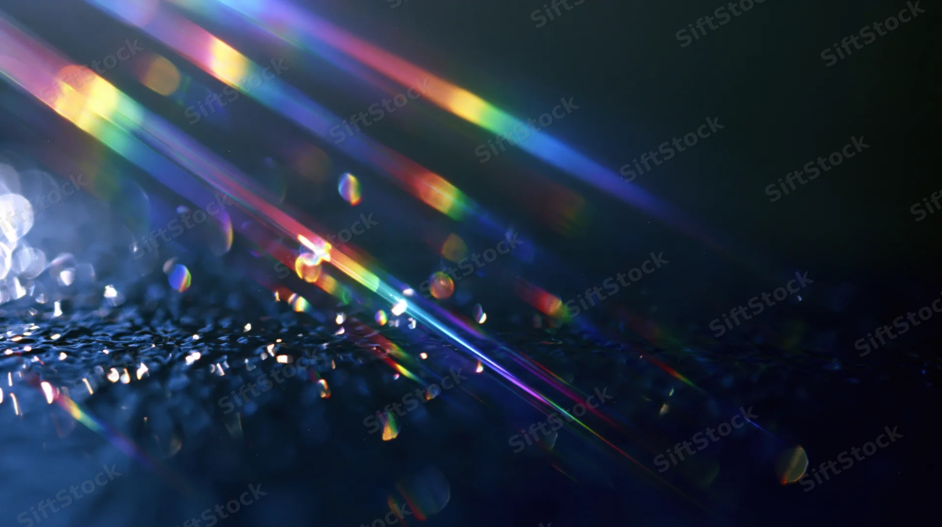 Colorful light beams refracting across a dark textured surface with bokeh highlights