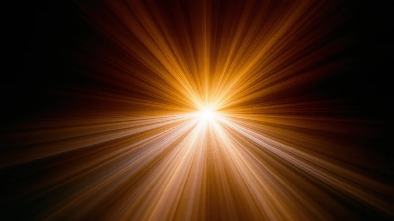Radiant light burst with golden rays emanating from center against dark background