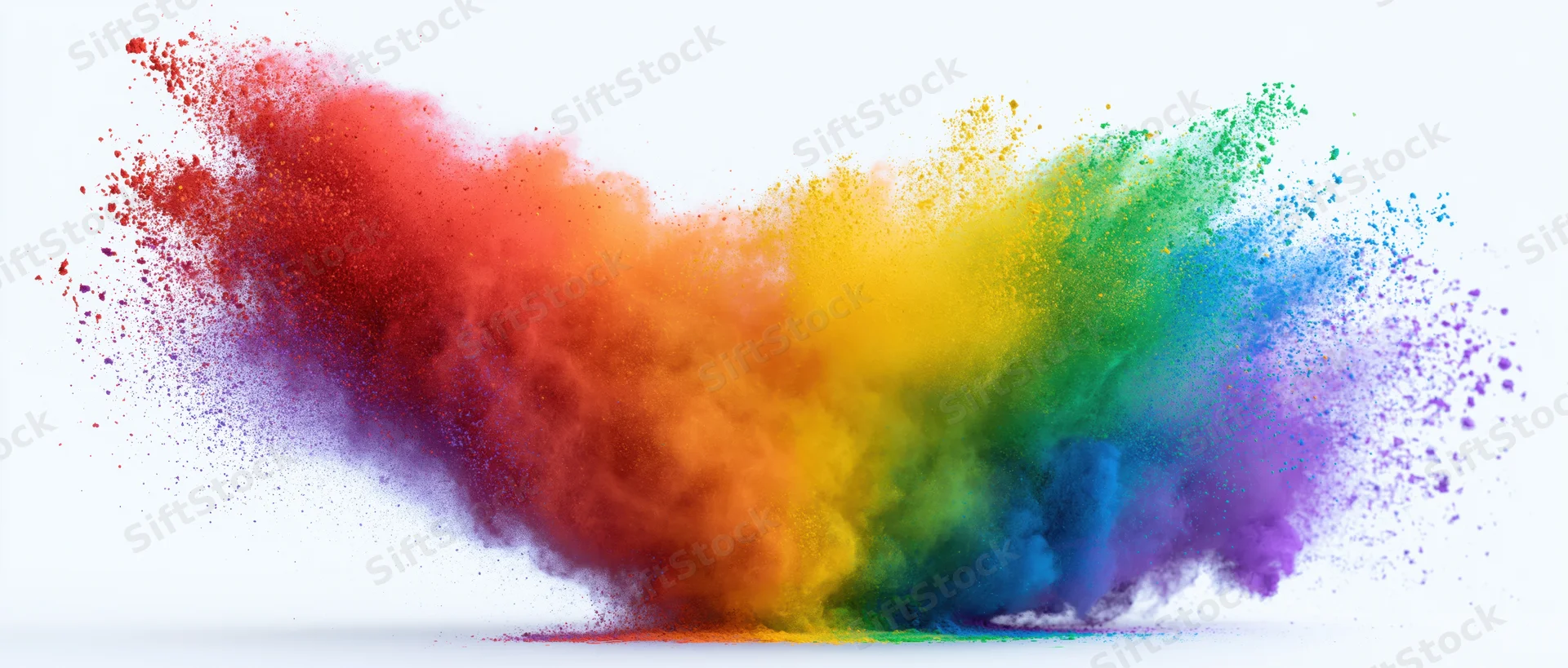 Colorful powder explosion in mid-air against white background