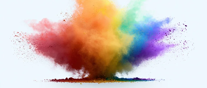 Colorful powder exploding in mid-air against a white background