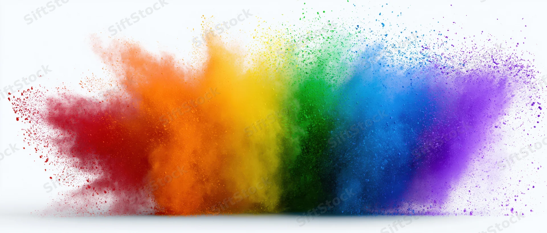 Rainbow-colored powder exploding in mid-air against a white background