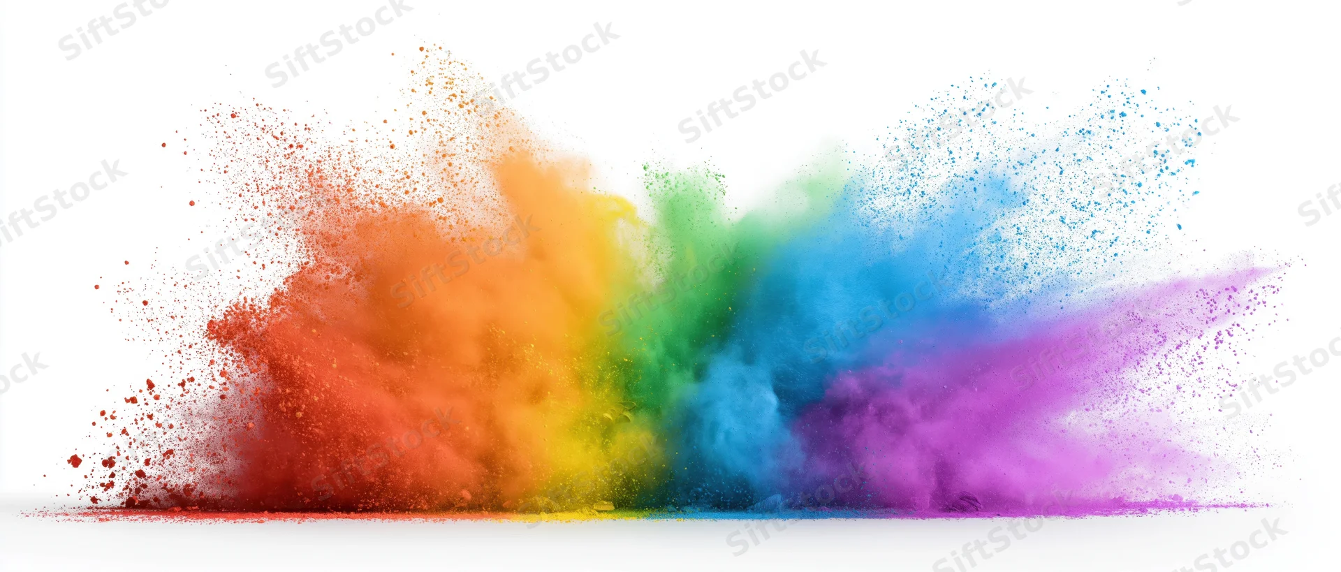 Colorful powder exploding in mid-air against white background