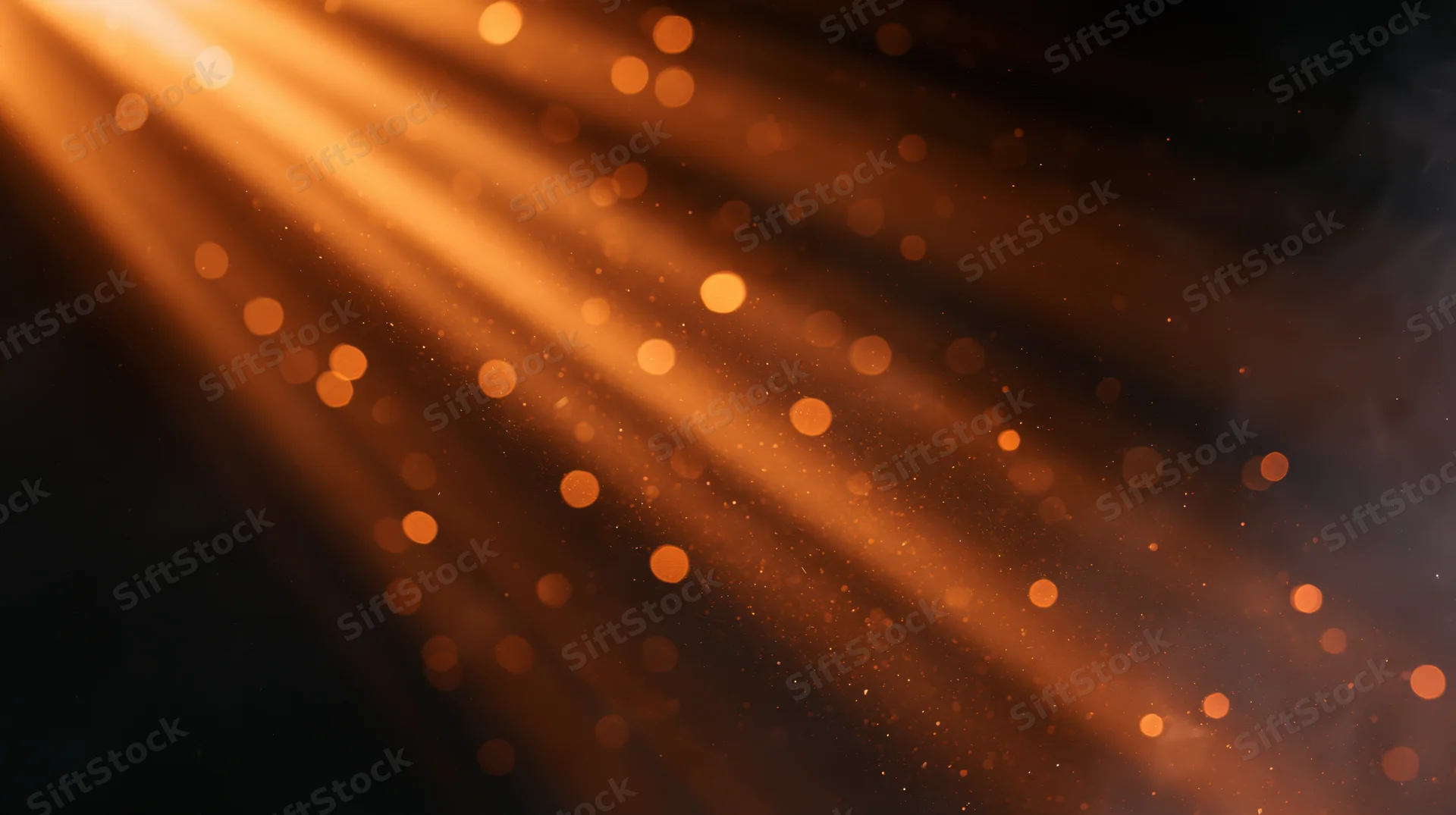 Warm light rays with floating particles and bokeh in a dark atmosphere