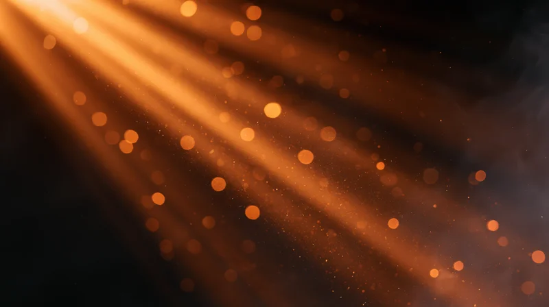 Warm light rays with floating particles and bokeh in a dark atmosphere