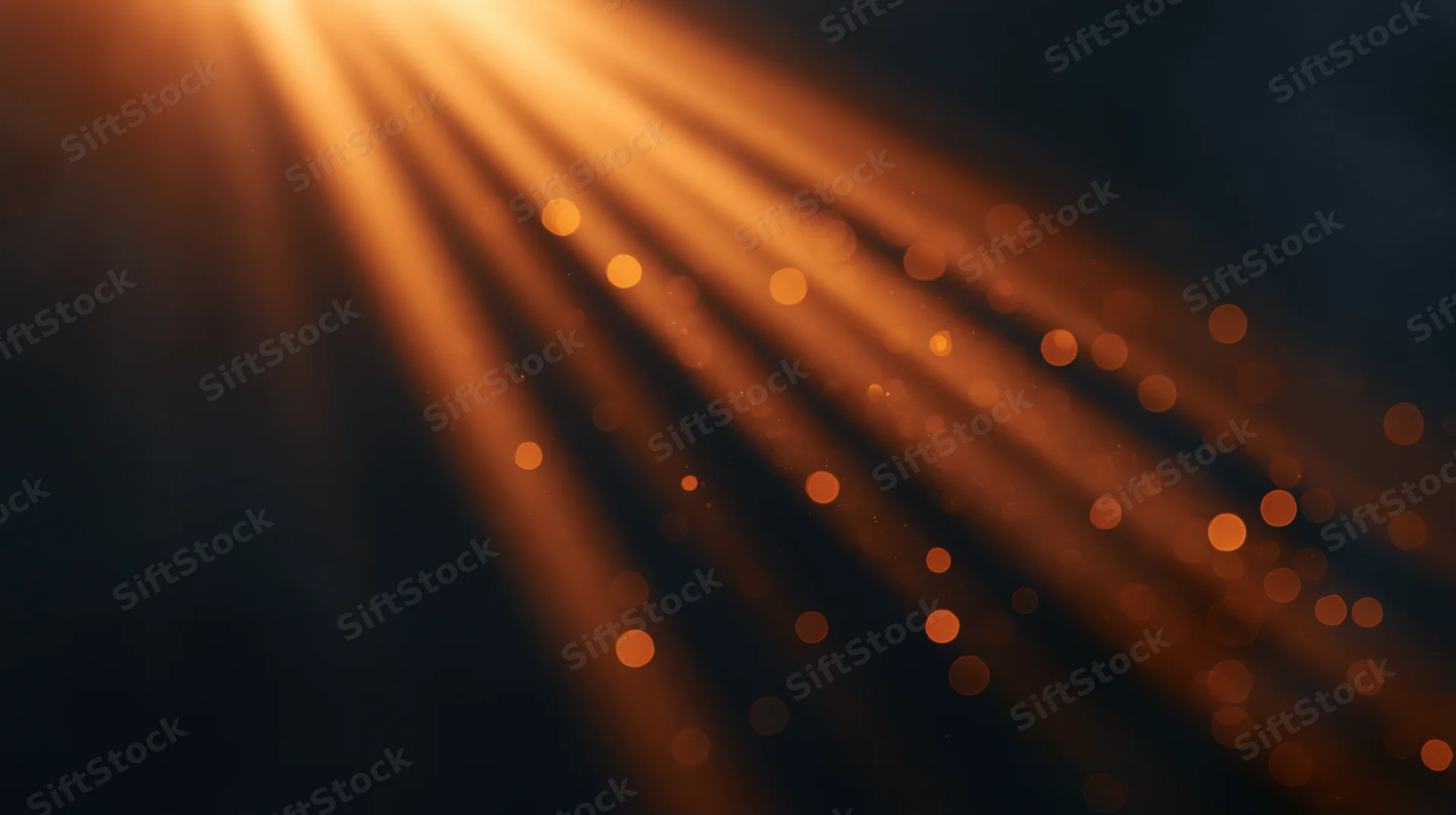 Golden light rays with bokeh particles in dark background