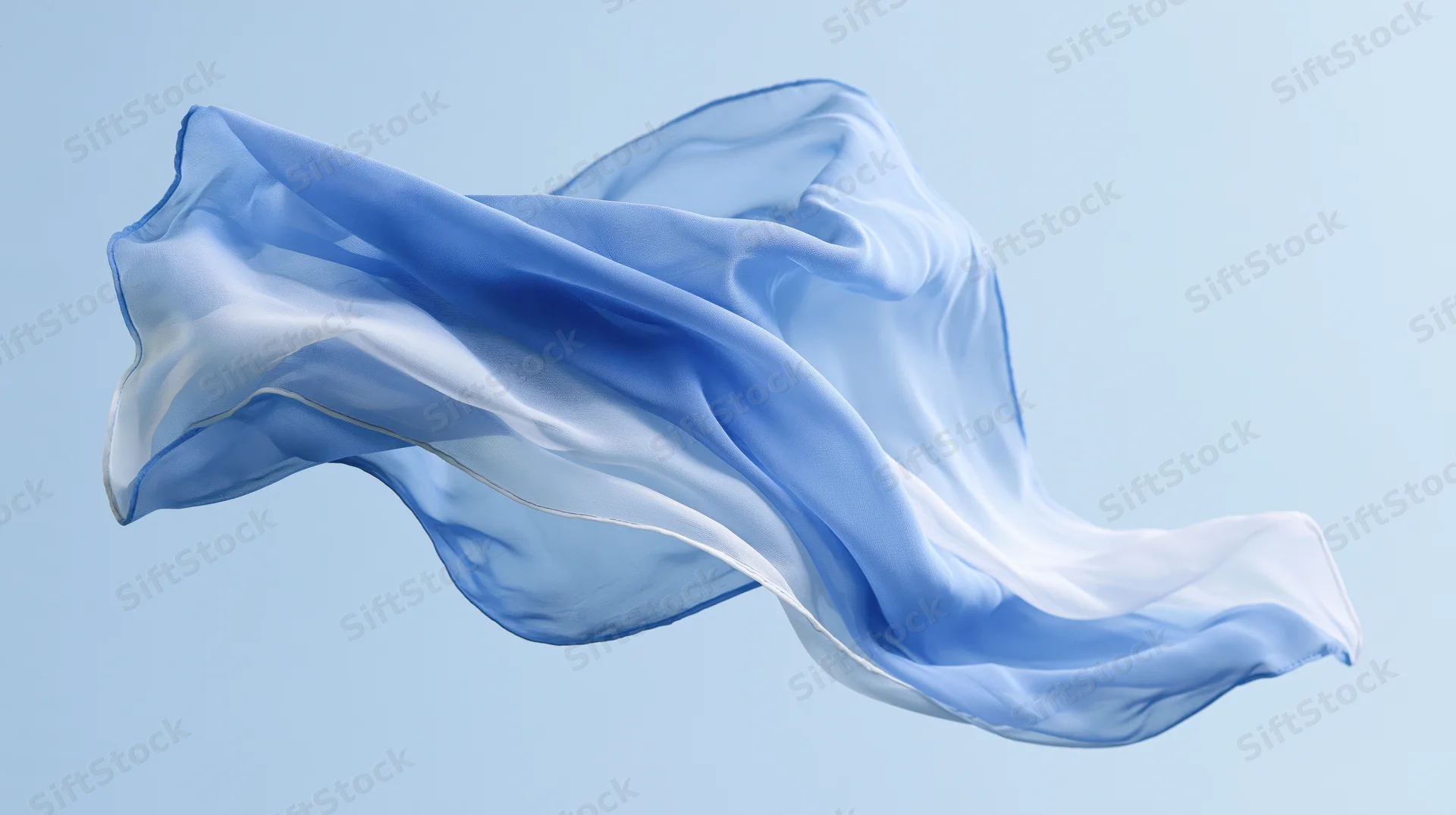 Flowing blue and white silk fabric suspended in motion against a light blue background