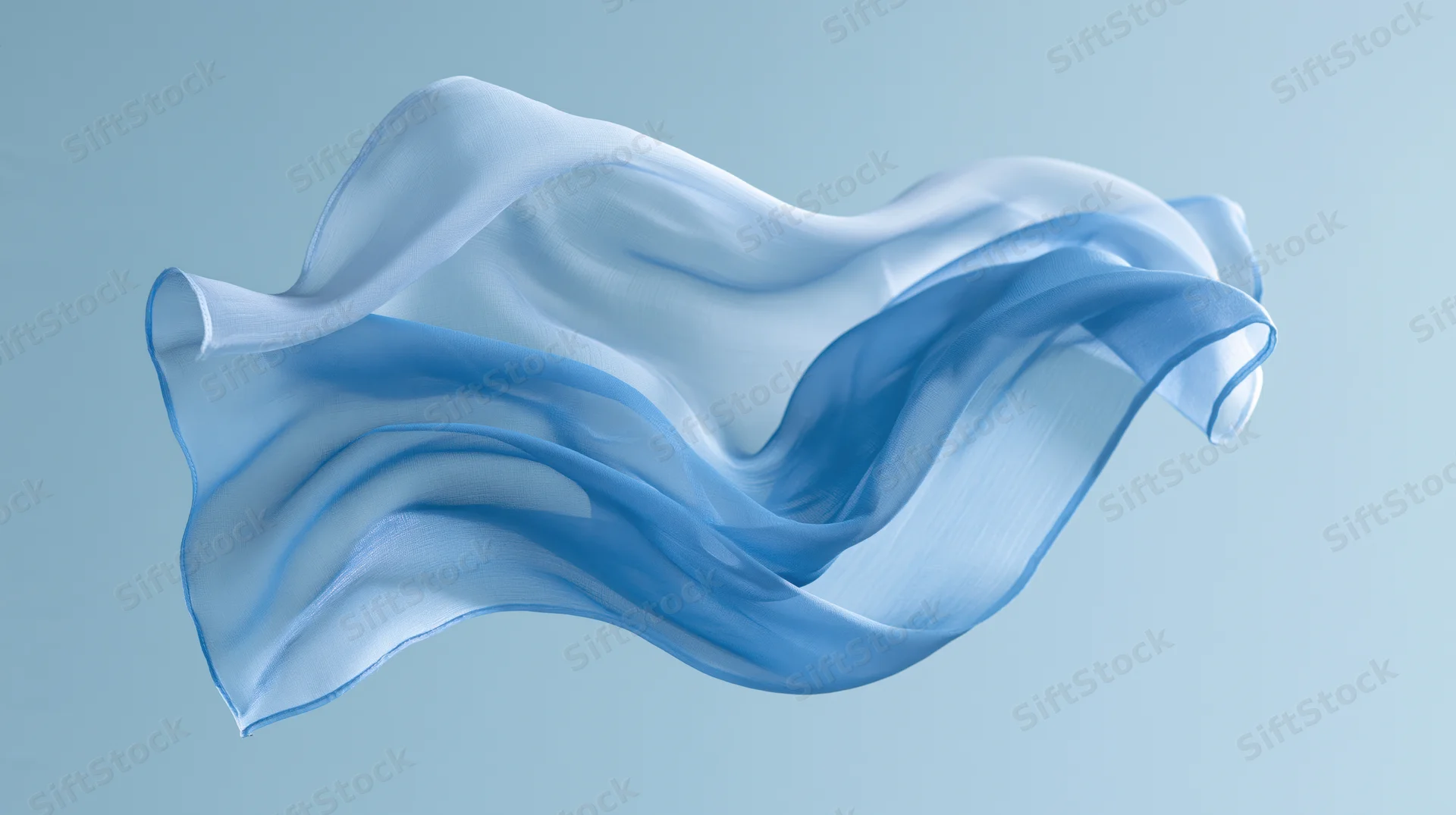 Flowing blue silk fabric suspended in motion against a light blue background
