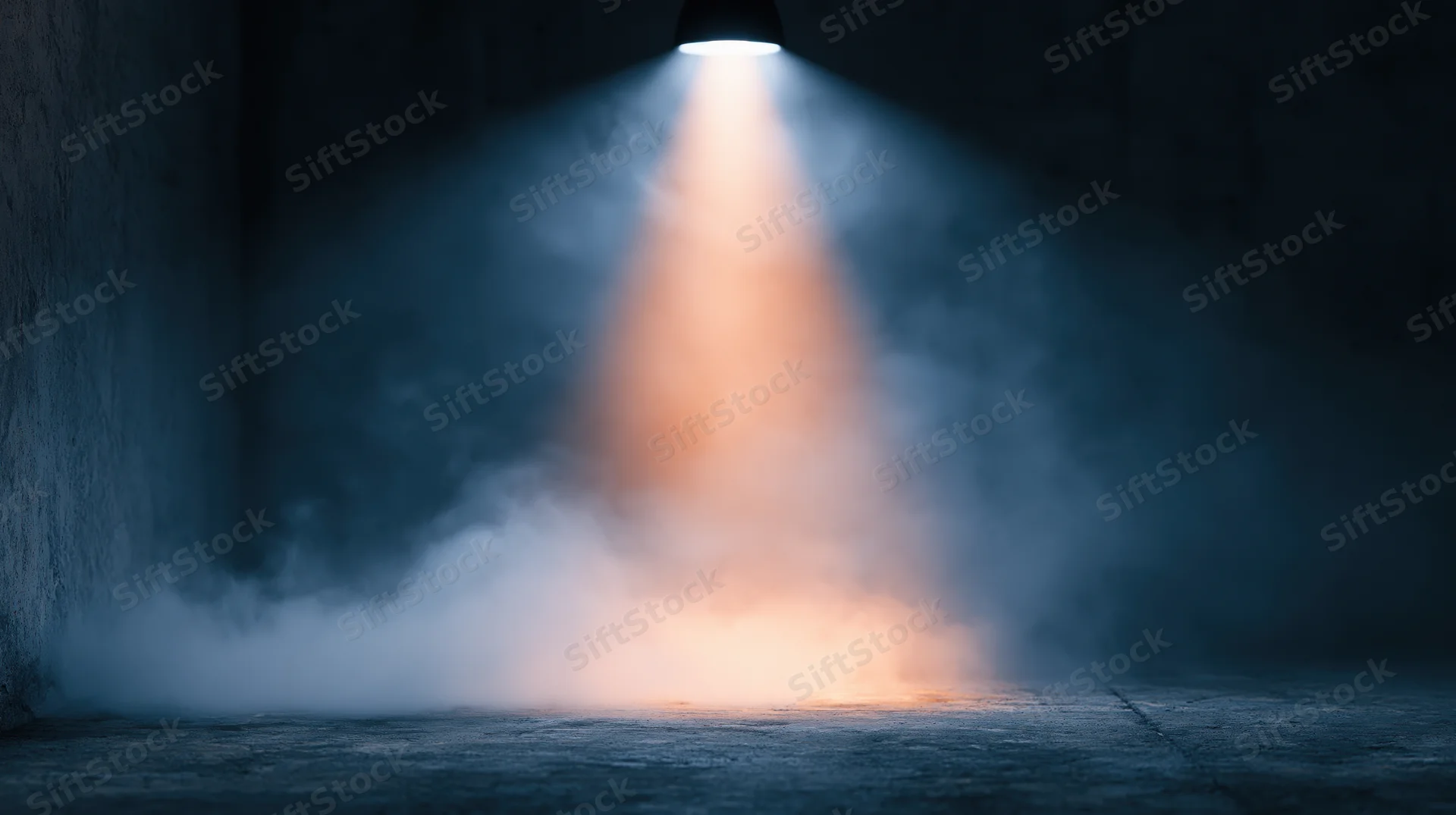 Spotlight beam cutting through smoke in a dark industrial space