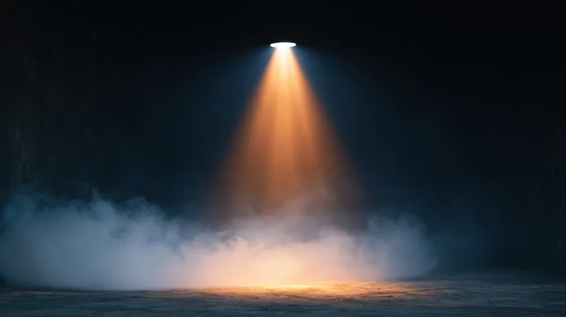 Spotlight beam cutting through smoke in a dark space