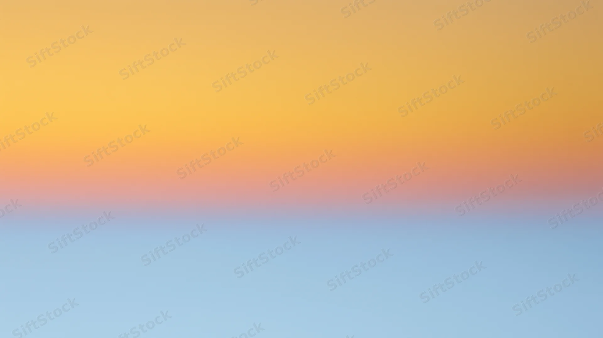 Gradient sky at sunset with orange and blue hues blending across the horizon