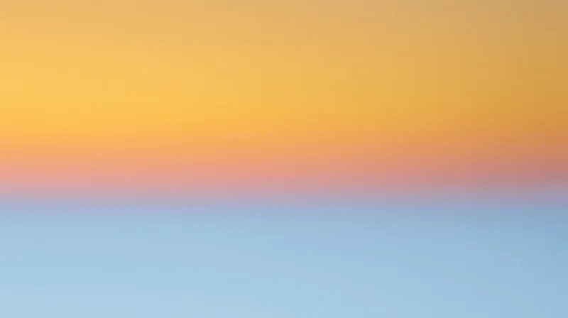 Gradient sky at sunset with orange and blue hues blending across the horizon