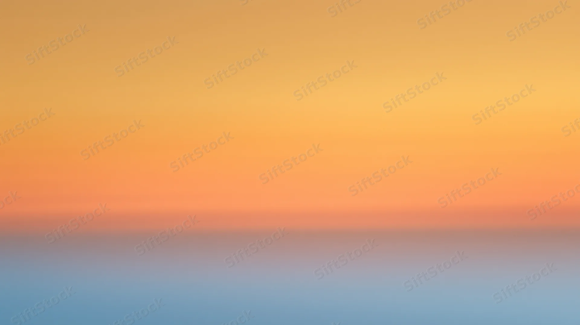 Gradient sky at dusk with orange and blue hues blending across the horizon