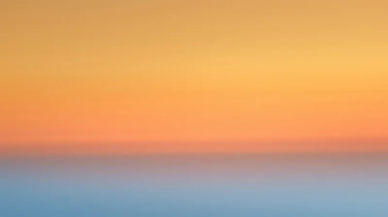 Gradient sky at dusk with orange and blue hues blending across the horizon